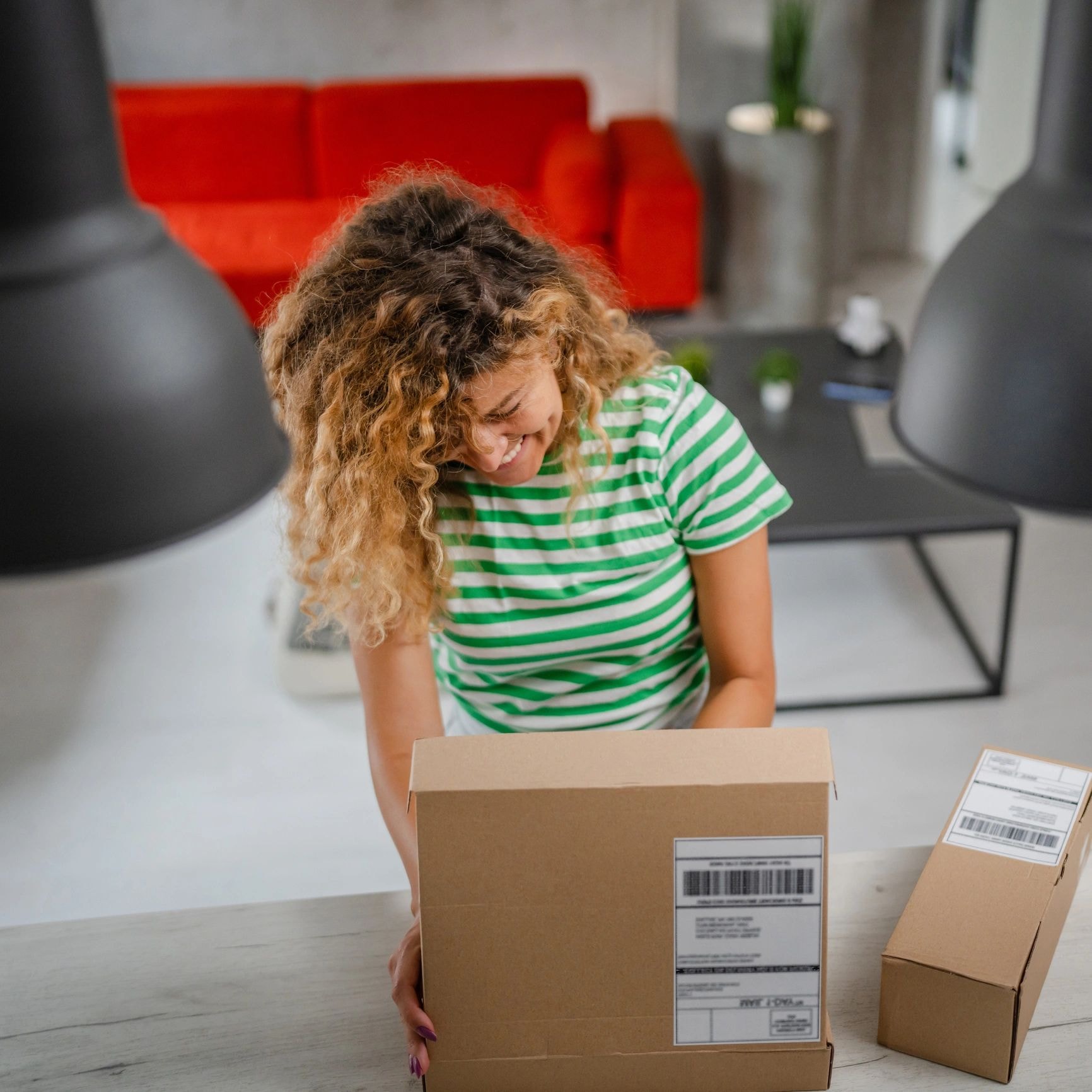 Child happily unboxing a cardboard shipping box