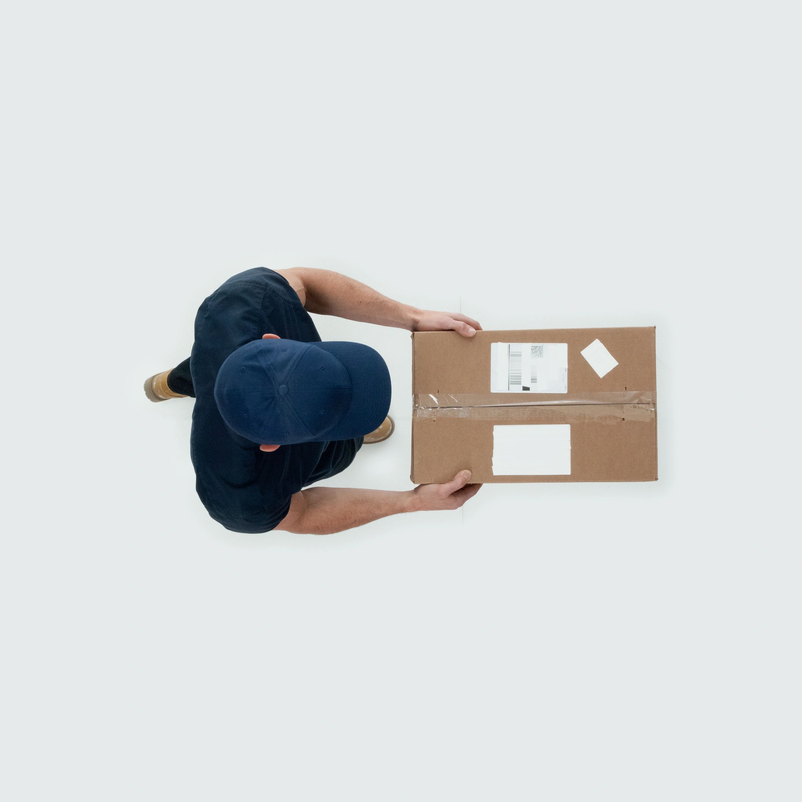 Overhead view of a person holding a cardboard shipping box